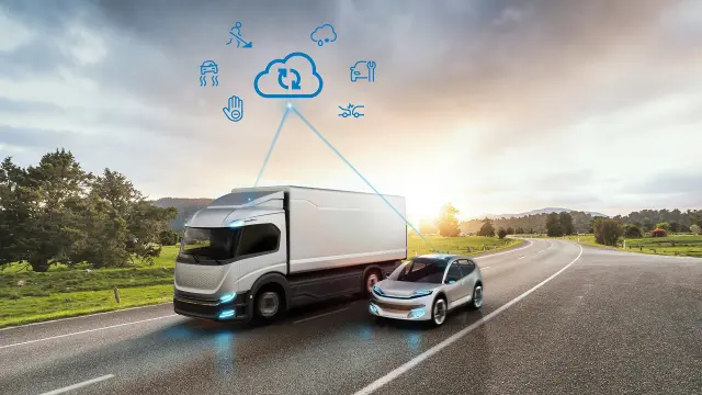 Ein futuristischer Lkw und ein Auto auf einer Straße mit Symbolen, die Konnektivität und Technologie darstellen.