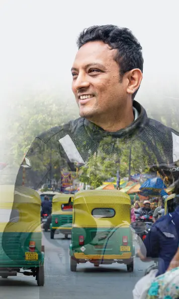 Person on a light background, overlaid with a street scene showing multiple vehicles.