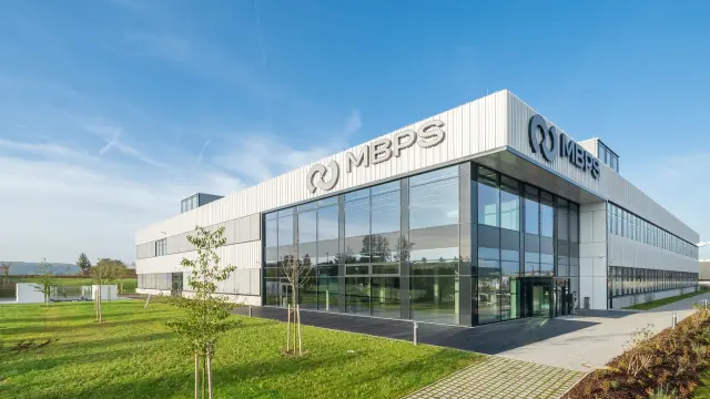 MBPS office building with glass facade and company logo.