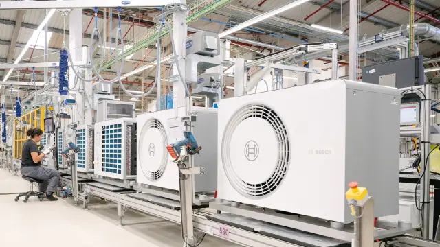 Production line with Bosch heat pump units in a factory.