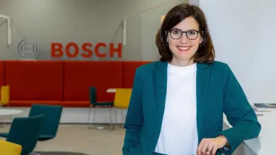 A person is standing in front of the Bosch logo, which can be seen in the background.