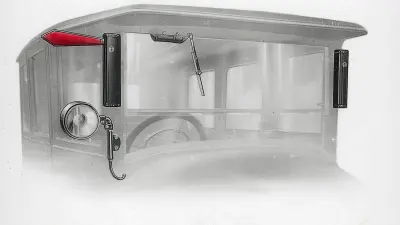 Front of an old car with red metal part extended out and to the right on the roof at the front