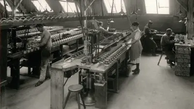 Produktionssaal mit Arbeitstischen und Fließband