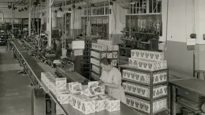 workers packaging bicycle light in a production hall