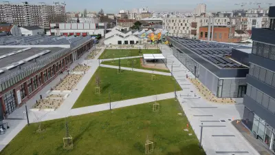 Green inner courtyard surrounded by industrial buildings