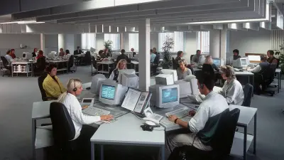 Open plan office with employees and headsets