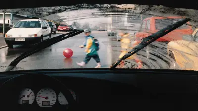 Left side of the pane with a clear view of children on the street, right side heavily smudged