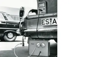 Rear view of a car with a device for measuring exhaust emissions. 