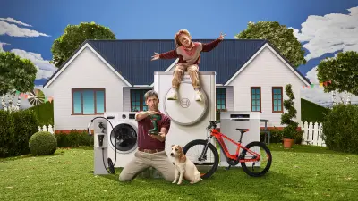 Man and child with Bosch products in front of a house.