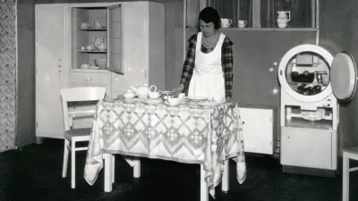 Woman in kitchen with an open fridge