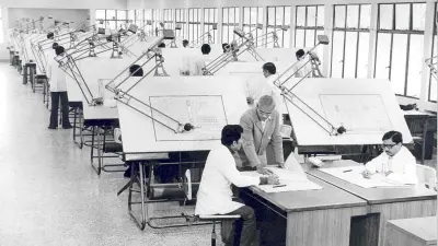 Employees at large-scale professional drafting boards