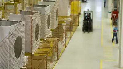 Washing machine covers hang in a factory hall.