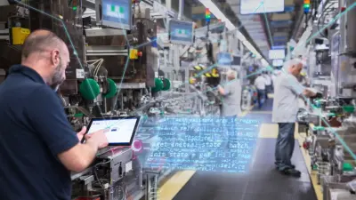Man with a touchpad in a factory building