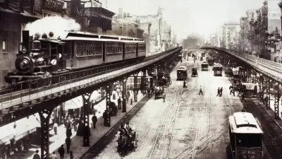Street scene with rails and train of the elevated railroad