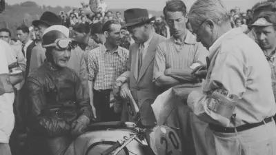 Bamminger with a motorcycle racer at the German Grand Prix on the Solitude race track in 1951.