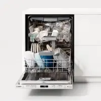 An open dishwasher filled with clean dishes