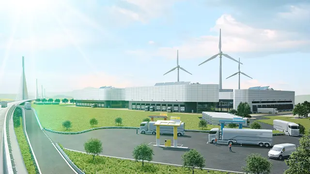 Ein futuristisch gestalteter Lkw fährt auf einer großen Straße in einer modernen Industrieszenerie.
