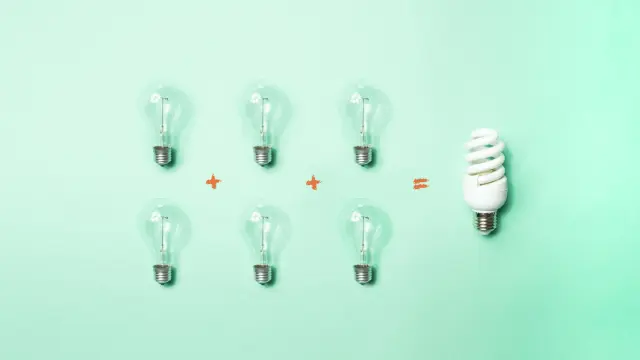 Equation showing two rows of three lightbulbs on the left and one energy-saving lightbulb on the right.