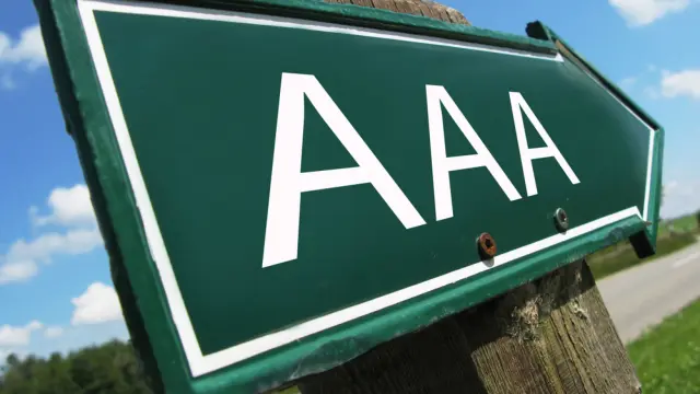 Green shield with white lettering and the letters AAA