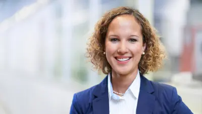 Young woman smiles at the camera.