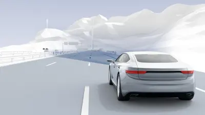 White autonomous vehicle driving on a highway in snowy winter conditions with mountains in the background, demonstrating Bosch's deep learning applications for driver assistance systems and automated driving.