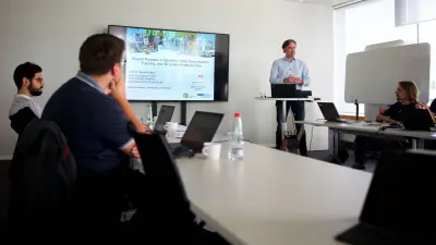 Photo of Prof. Dr. Bastian Leibe at a meeting of the cooperation project in Renningen, Germany. The picture shows him giving a presentation about the project.