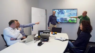 The Bosch Accident Research team around a desk, analyzing traffic and accident data.