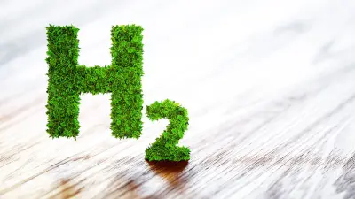Image of green hydrogen formula on wooden background symbolizing green energy.