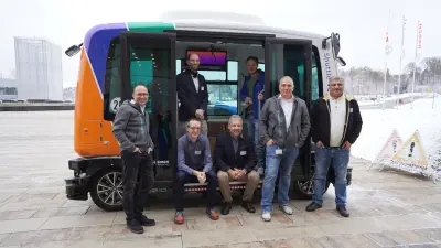 The Bosch team from the funding project stands in front of the EVA shuttle, a Bosch demonstrator from "KIsSME".