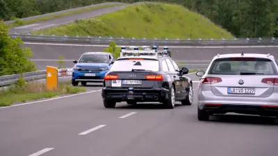 Three cars on the test track at the Aldenhoven Testing center