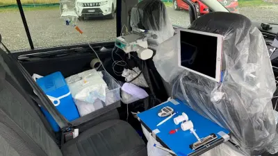 Research on Driver Health at Bosch IoT Lab - Rear view of the vehicle with medical equipment and tablets attached to the front seat headrests.