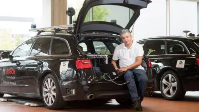Dr. Koba Natroshvili in front of a car