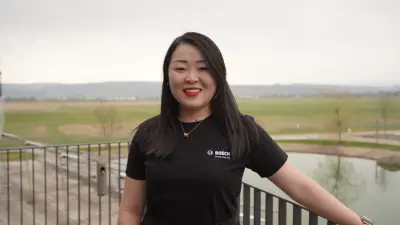 Research expert Dr. Xia Lijuan (Bella) on the balcony with a view of the pond at the Bosch Research Campus in Renningen, Germany.
