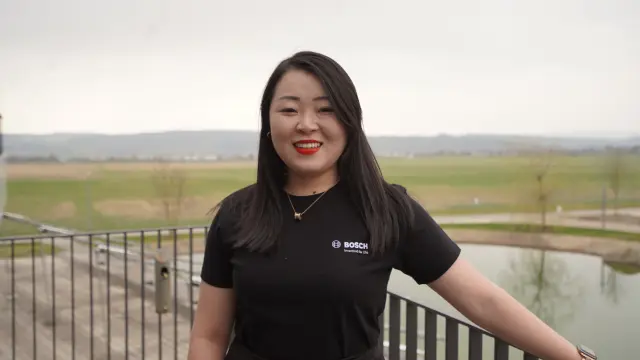 Research expert Dr. Xia Lijuan (Bella) can be seen on a balcony with a view of the pond at the Bosch Research Campus in Renningen.