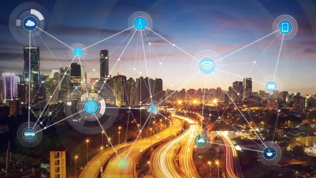 The background shows a city at night. In the foreground, different icons are connected with lines, like synapses.