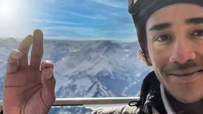 Snowboarder Yanneck Konda presenting a tiny sensor on the tip of his finger.