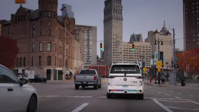 Test vehicle driving on a city street with sensor equipment on the roof