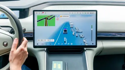 Driver’s view of a central touchscreen showing navigation and traffic data