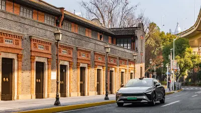 Car driving along a city street with historic buildings