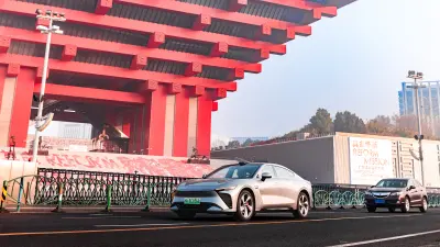 Car driving past traditional buildings in an urban street scene