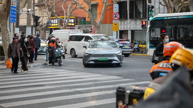 City street view with cars driving through an urban area