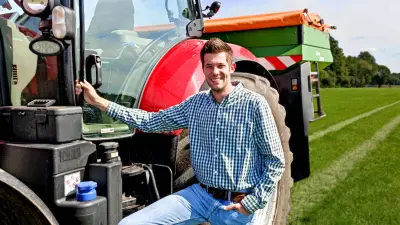 Landwirt Uwe Thumann steht neben seiner landwirtschaftlichen Maschine nach seinem Dünge Einsatz. 