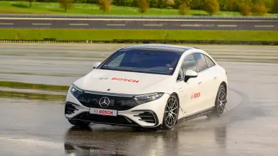 The test vehicle drives a sharp curve on the Bosch test site in Boxberg.