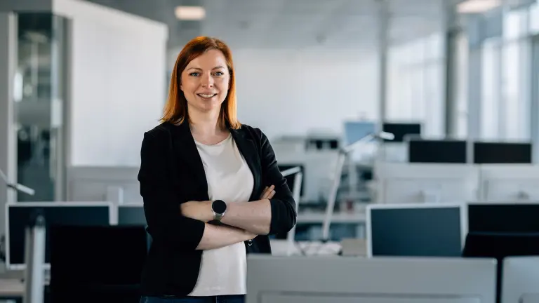 A person stands at a desktop