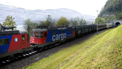 In Switzerland, an SSB Cargo freight train emerges from a tunnel