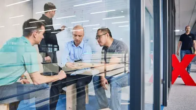Sebastian Krauskopf is sitting with three other people from his team at Bosch Rexroth.