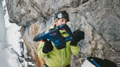 Bernhard Witz uses a cordless Bosch Biturbo rotary hammer. Its 18-volt lithium-ion battery gets him through an entire day on the ice.