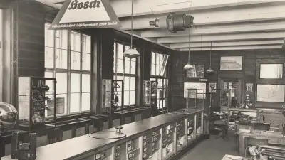 A black and white photograph captures the interior of a Bosch store, from the early to mid-20th century.