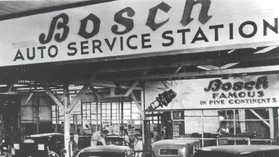 A vintage black and white photograph of a Bosch Auto Service Station.
