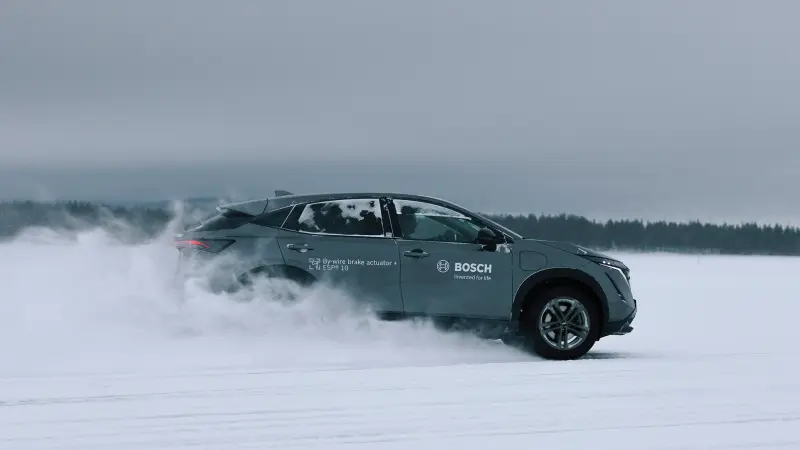 A Bosch test car with brake-by-wire drives through the snow.